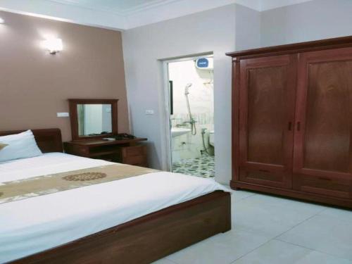 a bedroom with a bed and a bathroom with a tub at Love Hotel in Hanoi