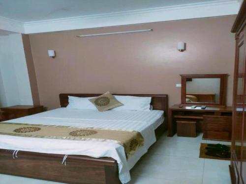 a bedroom with a bed and a mirror at Love Hotel in Hanoi