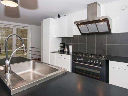 a kitchen with a sink and a stove at 10 person holiday home in Ebeltoft-By Traum in Ebeltoft