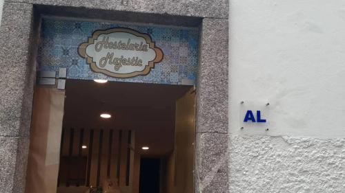 a sign on the side of a building at Majestic Hostel Porto in Porto