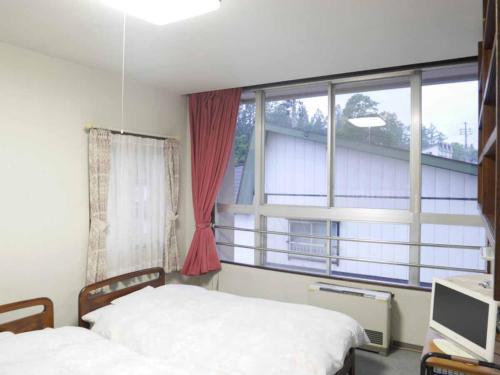 Postel nebo postele na pokoji v ubytování ホテルヴィレッジ圓山