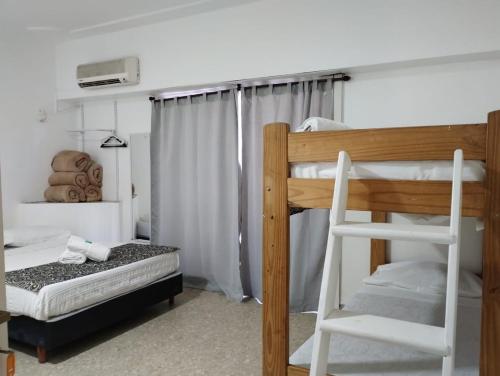 a bedroom with two bunk beds and a ladder at HOSTAL con terraza y parrilla en Palermo in Buenos Aires