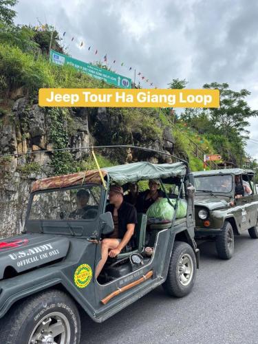 a group of people riding in a jeep tour liaching loop at Ha Giang Rabbit Hostel & Tours in Ha Giang