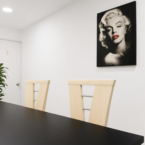 a picture of a woman on a wall with two chairs at Casa Hotel Sweet Home Apt 203 Bed & Breakfast Grupos in Medellín