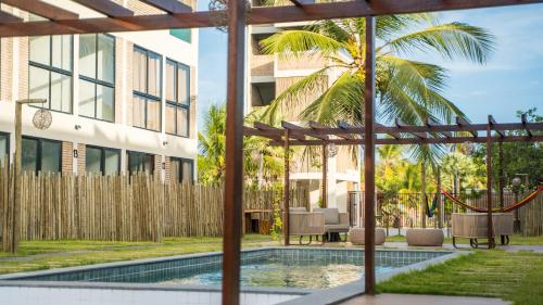 a courtyard with a swimming pool and a building at Casa 12 do Paraíso - Atins in Atins