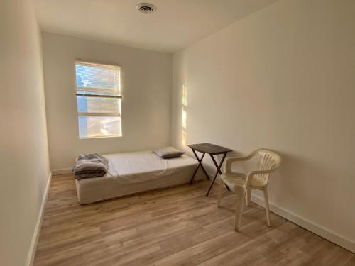 a bedroom with a bed and a table and a chair at 郊区安静民宿 