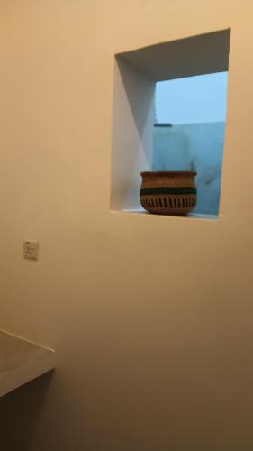 a bowl is sitting on a shelf in a room at Zanzibar Dream Lodge in Bwejuu