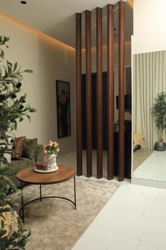 a living room with a table and a couch at The District in Jeddah