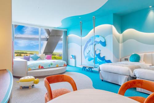 a childrens bedroom with two beds and a dolphin mural at KAMENOI HOTEL Kujukuri in Asahi