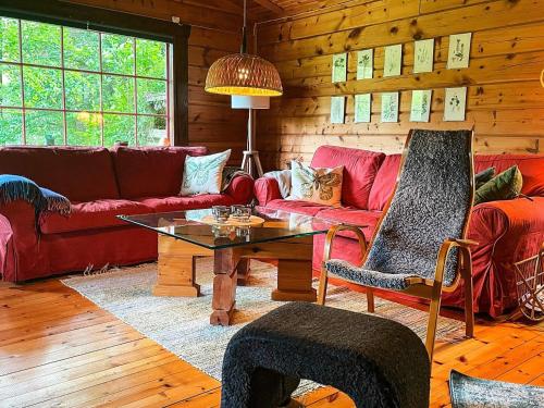 a living room with a red couch and a table at 6 person holiday home in blentarp-By Traum in Blentarp