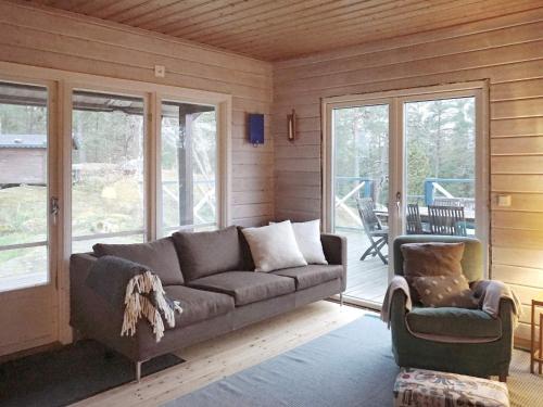 a living room with a couch and a chair at 7 person holiday home in INGARÖ-By Traum in Hanskroka