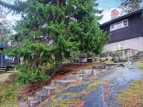 a house with a tree and some concrete steps at 7 person holiday home in INGARÖ-By Traum in Hanskroka