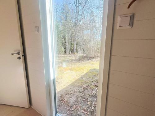 an open door with a view of a yard at 6 person holiday home in RÖRVIK in Rörvik