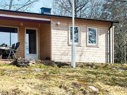 a small house with a chair in front of it at 6 person holiday home in RÖRVIK in Rörvik