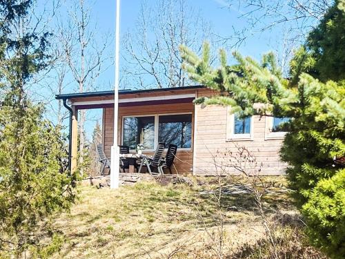 a small house on a hill with a table and chairs at 6 person holiday home in RÖRVIK in Rörvik