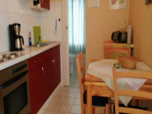 a kitchen with a table and a dining room at Boutique Bungalow in Insel Poel with terrace in Insel Poel
