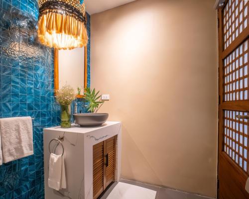 a bathroom with a sink and a mirror at Villa Sima - Tropical Elegance in central Panglao in Panglao