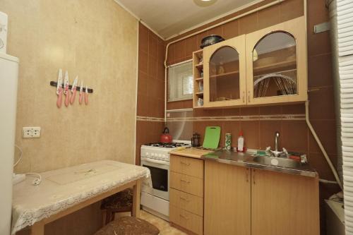 a kitchen with a sink and a stove at Apartments Colonnade in Kislovodsk