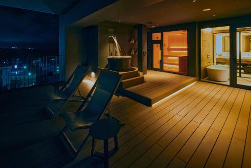 a bathroom with a tub and a toilet and a balcony at edit x seven FUJI GOTEMBA in Gotemba