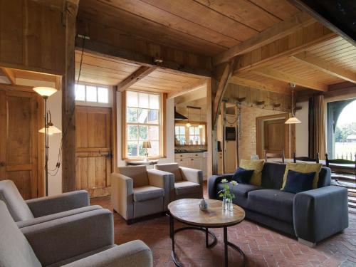 a living room with couches and a table at Cozy Apartment in Enschede near Forest in Enschede