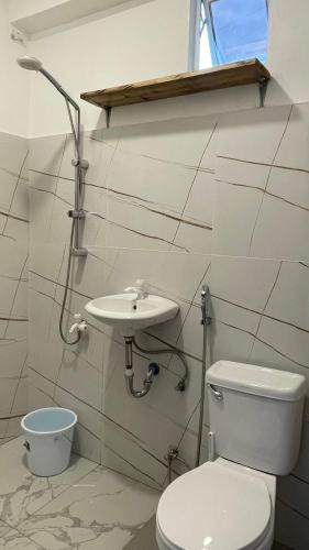 a bathroom with a toilet and a sink at Padayon Island Stay in General Luna