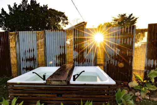 a bath tub sitting in front of a fence at Wallaby by Tiny Away in Thoopara