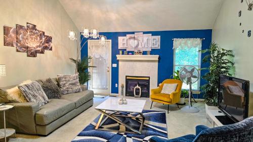 a living room with a couch and a fireplace at Beautiful Townhome, 11 minutes to Downtown, KCMO. in Kansas City