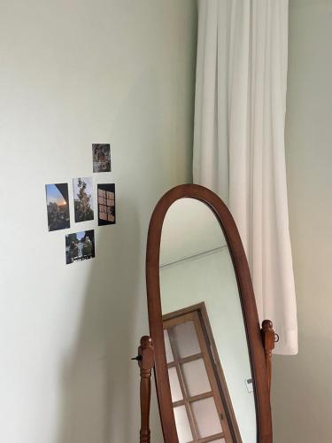 a mirror next to a window with pictures on the wall at Minharu house in Busan