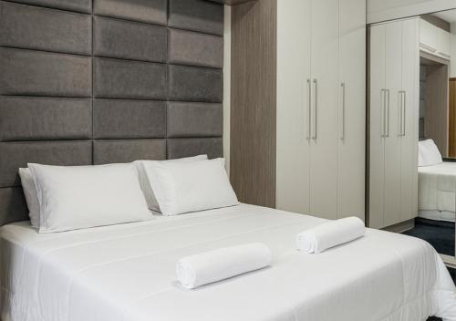 a white bed with two white pillows on it at Apartamentos Porto Maravilha in Rio de Janeiro