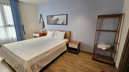 a bedroom with a large bed and a mirror at Home stay 2pn Hạ Long in Ha Long