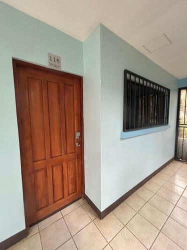 a room with a wooden door and a tile floor at Marina Loft in Coco