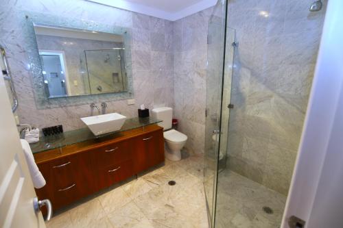 a bathroom with a shower and a sink and a toilet at Houses in Goulburn in Goulburn