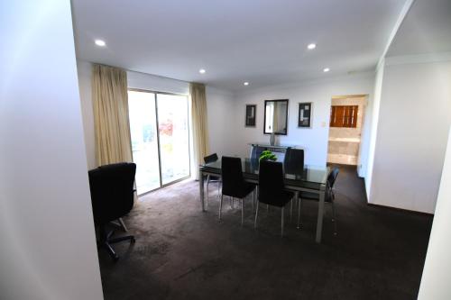a living room with a dining room table and chairs at Houses in Goulburn in Goulburn
