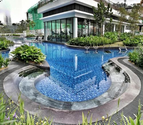 a large swimming pool in front of a building at Cozy 2B at Midhills Genting in Genting Highlands