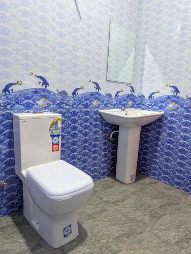a bathroom with a toilet and a sink at Ethili Lake view & Safari Camp in Wellawaya