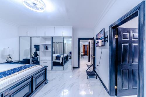 a bedroom with a bed and a large door at Platinum22 - Across From AC Marriott Hotel in Kingston
