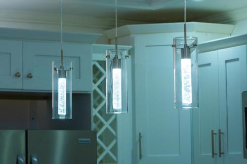 a kitchen with three lights hanging from the ceiling at Platinum22 - Across From AC Marriott Hotel in Kingston