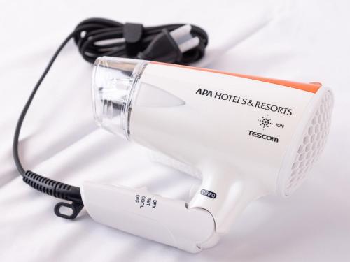 a hair dryer sitting on top of a white table at APA Hotel Takasakieki Higashiguchi in Takasaki