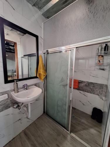 a bathroom with a shower and a sink at Casa de campo San Marcos in Pujilí