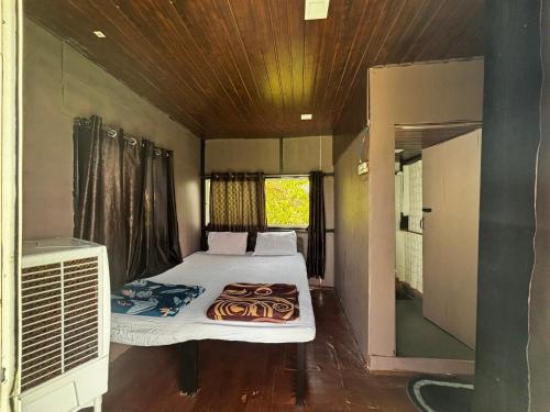 a room with a bed with a tiger blanket on it at Ingawale farmhouse (agro tourism) in Satara