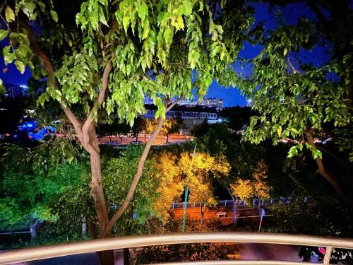 a view of a street at night with a tree at Gem's House 1- Balcony with Riverside View in Ho Chi Minh City