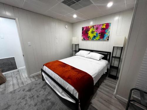 a bedroom with a bed with a painting on the wall at The Gorge Getaway 3BR 1BATH Close to Falls in Niagara in Niagara Falls