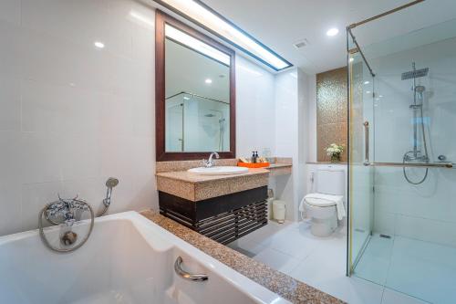 a bathroom with a tub and a sink and a shower at Khum Phucome Hotel -SHA Extra Plus in Chiang Mai