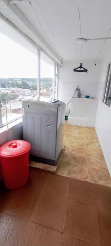 a bathroom with a tub in a room with a window at Apartamentos CasaMJ Tunja Confort y Parqueadero in Tunja