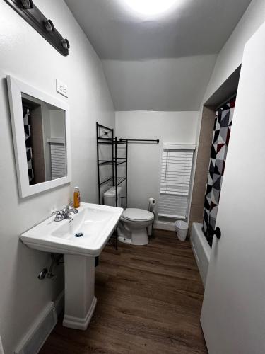 a bathroom with a white sink and a toilet at Casa Bella Niagara 2BR 1BATH 6PPL Close to Falls in Niagara Falls