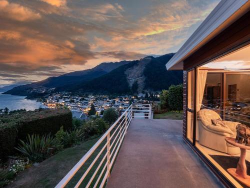 a house with a balcony with a view of a city at The view of Queenstown in Queenstown