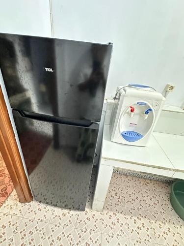 a refrigerator door is open in a kitchen with a blender at Ambon Residence Syariah in Ambon