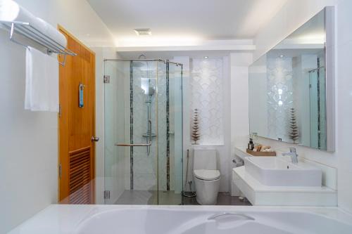 a bathroom with a shower and a toilet and a sink at Khum Phucome Hotel -SHA Extra Plus in Chiang Mai