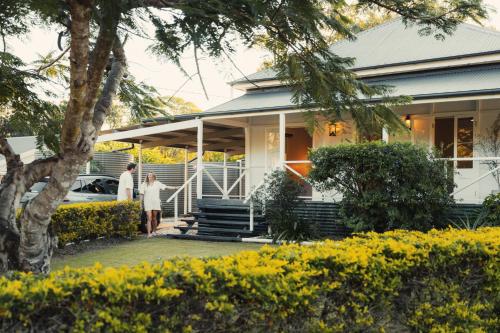 a couple standing in front of a house at Over The Road in South Bingera