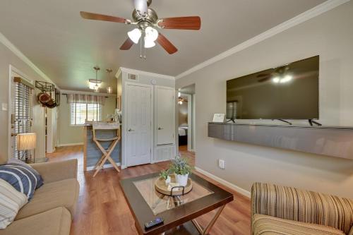 a living room with a couch and a ceiling fan at The Homestead Apartments- Walk to SFA Campus, Comfy, Children & Pet-Friendly Nacogdoches Condo in Nacogdoches